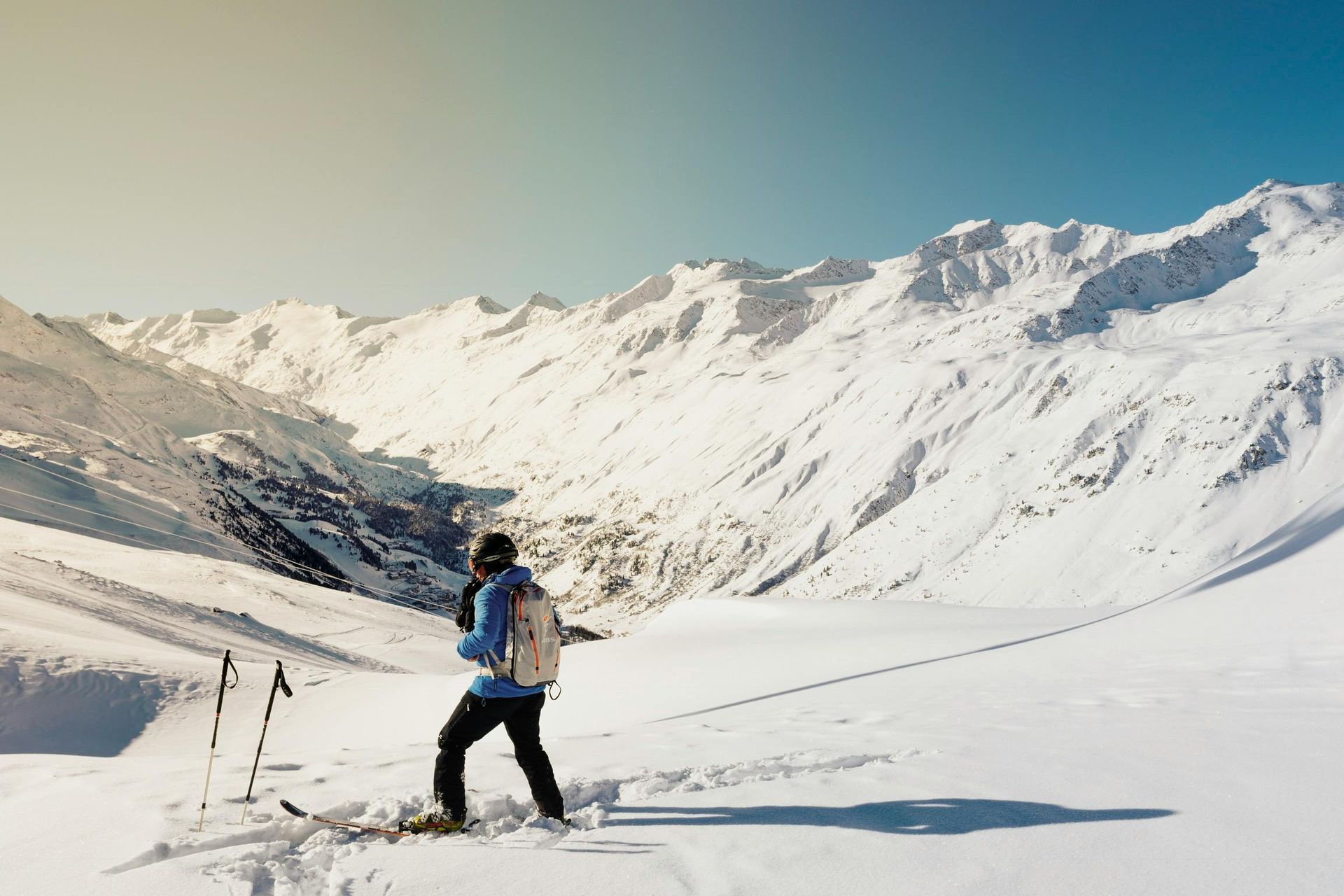 A person is skiing down a snow covered mountain.
