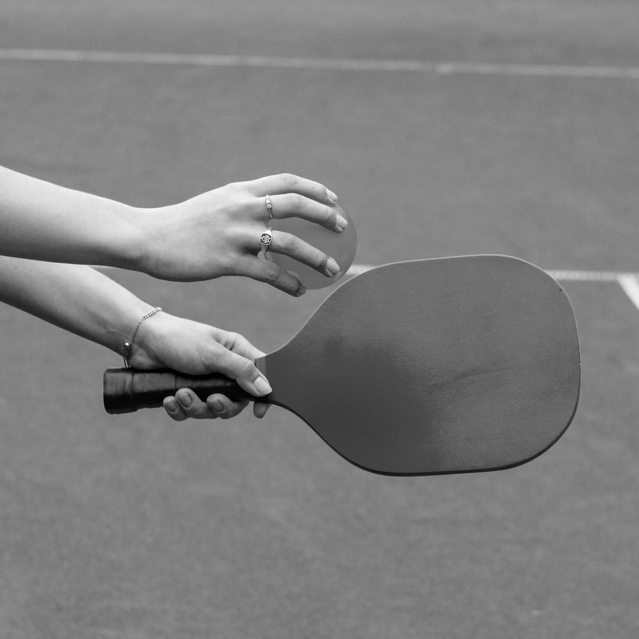 A black and white photo of a person holding a paddle