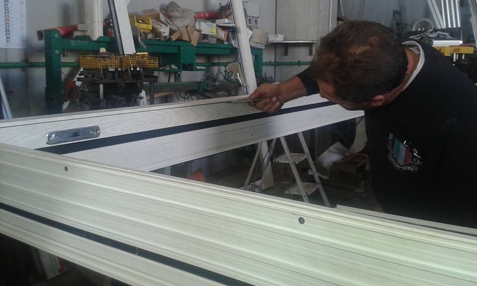 Un uomo sta lavorando su un pezzo di metallo in un'officina.