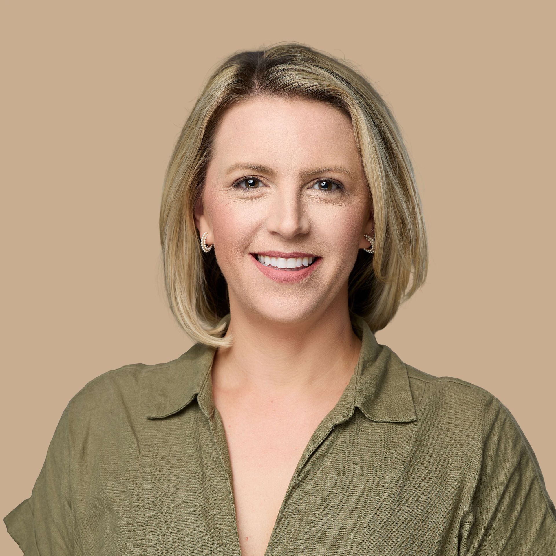 Professional headshot of a woman on a solid background