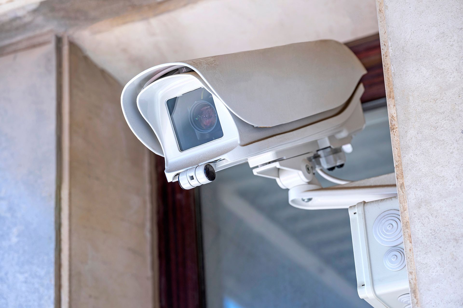 A security camera is mounted on the side of a building