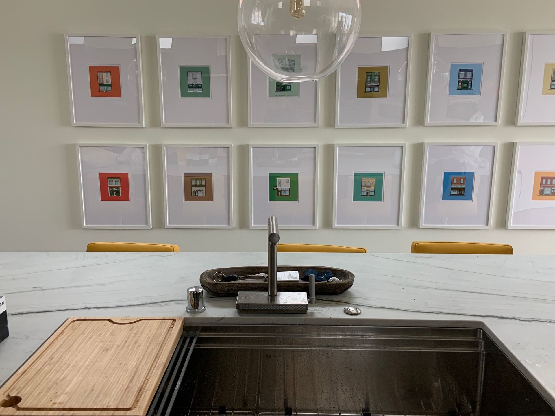 A kitchen counter with a sink and a cutting board