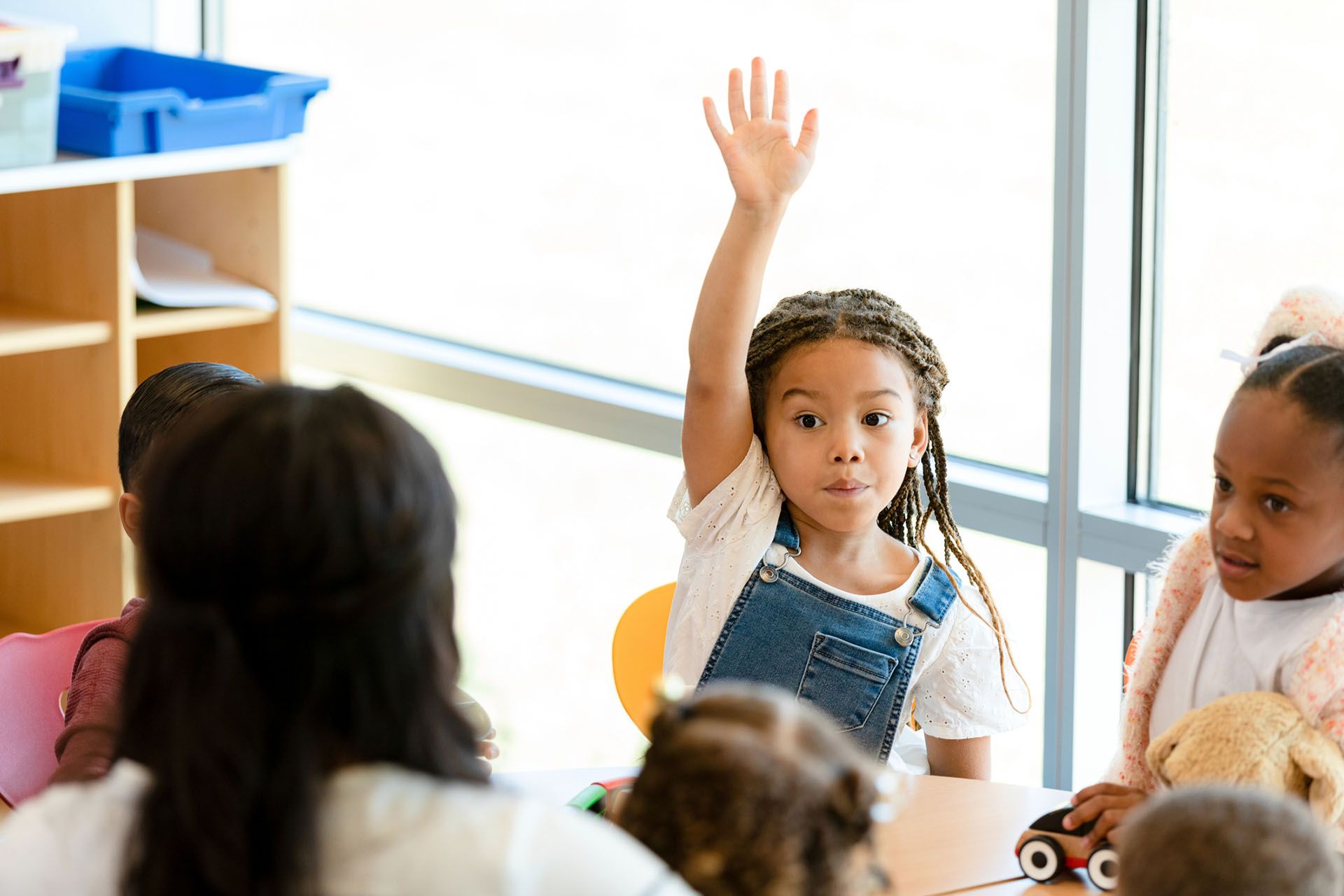 Little girl raises her hand — Ames, IA — Ames Community Preschool Center (ACPC)