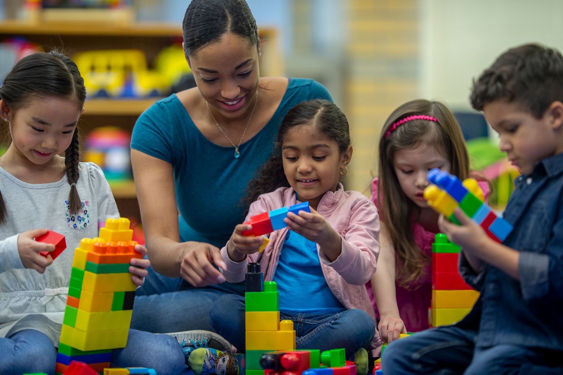 Elementary students playing colorful blocks together — Ames, IA — Ames Community Preschool Center (ACPC)