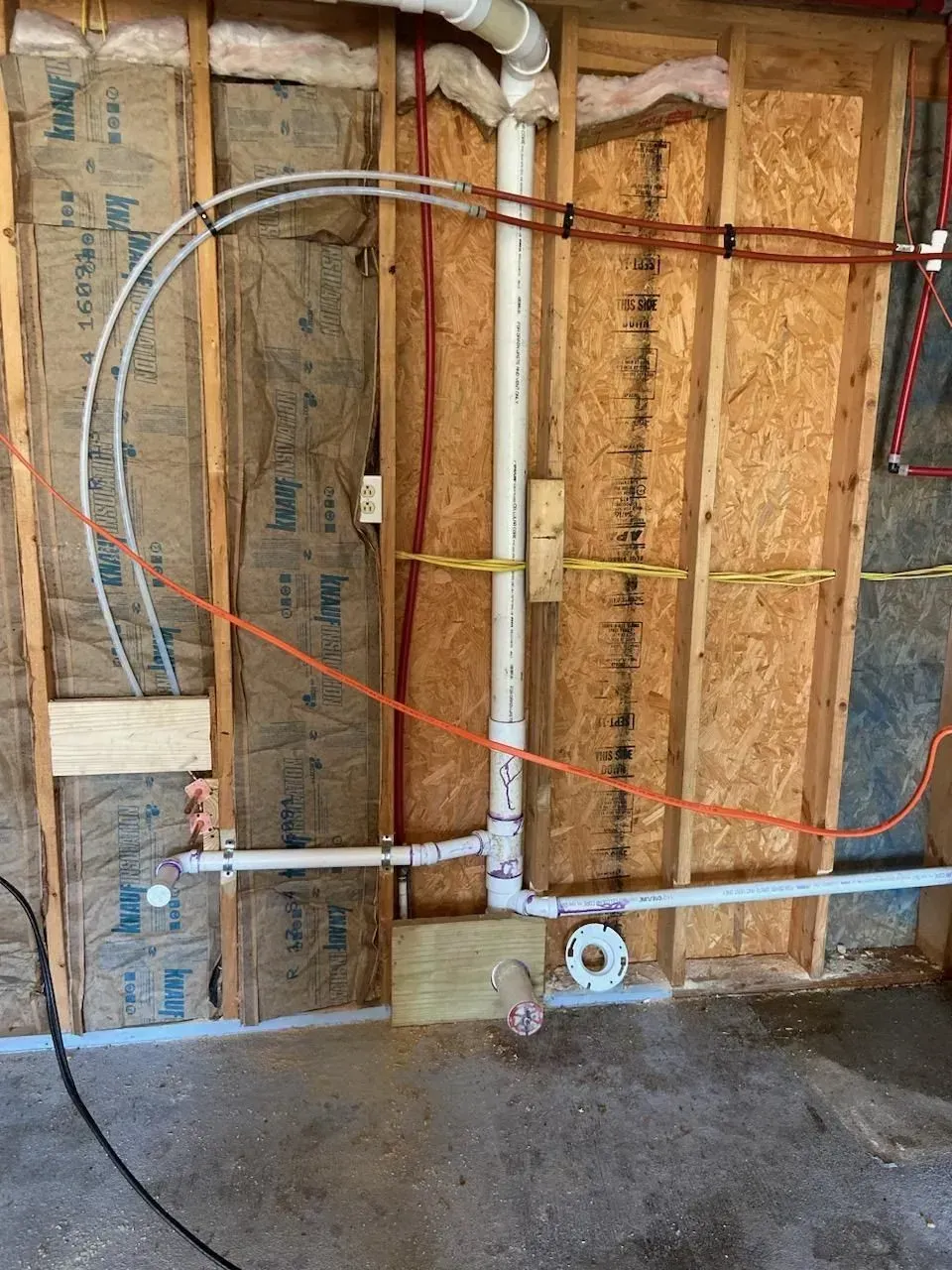A wall with a lot of wires coming out of it