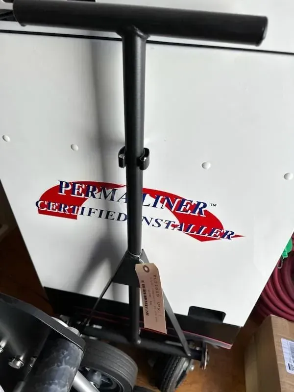A trolley with a tag on it sits in front of a permanent certified installer