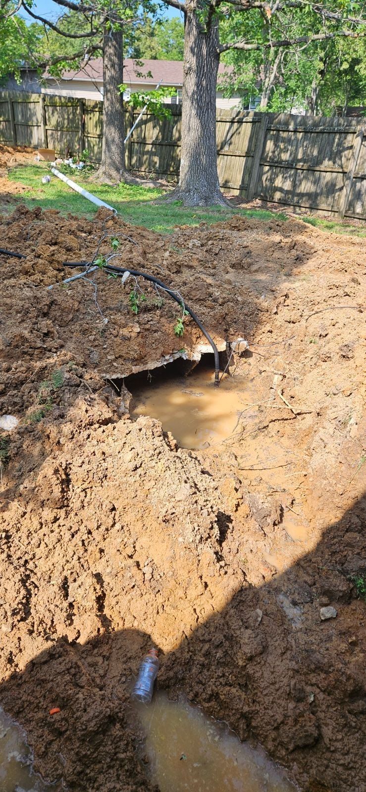 There is a puddle of water in the middle of the dirt.