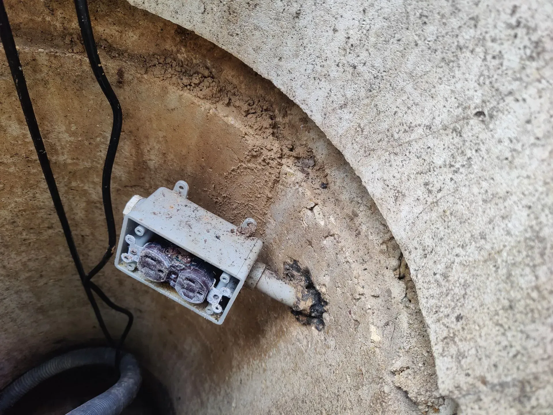 A white box is sitting on top of a concrete wall.