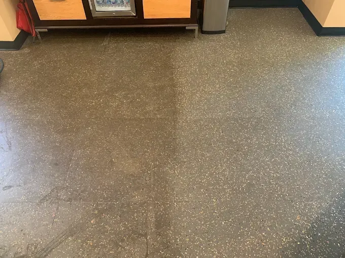 A comparison of a dark, dirty floor section on the left and a cleaner, lighter-toned section on the right.