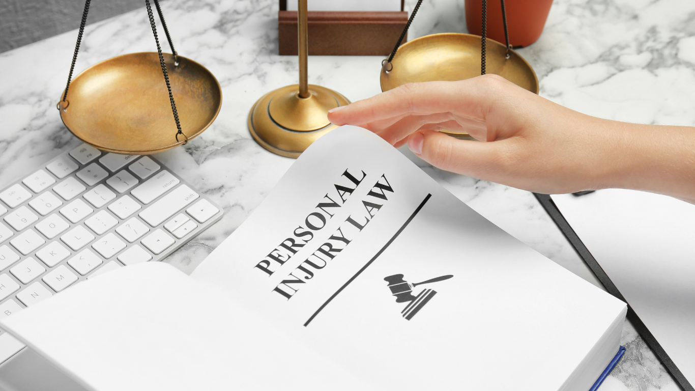 A person is holding a piece of paper that says personal injury law.