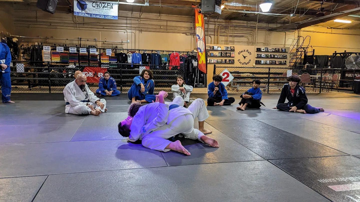 a man is laying on top of another man on a mat