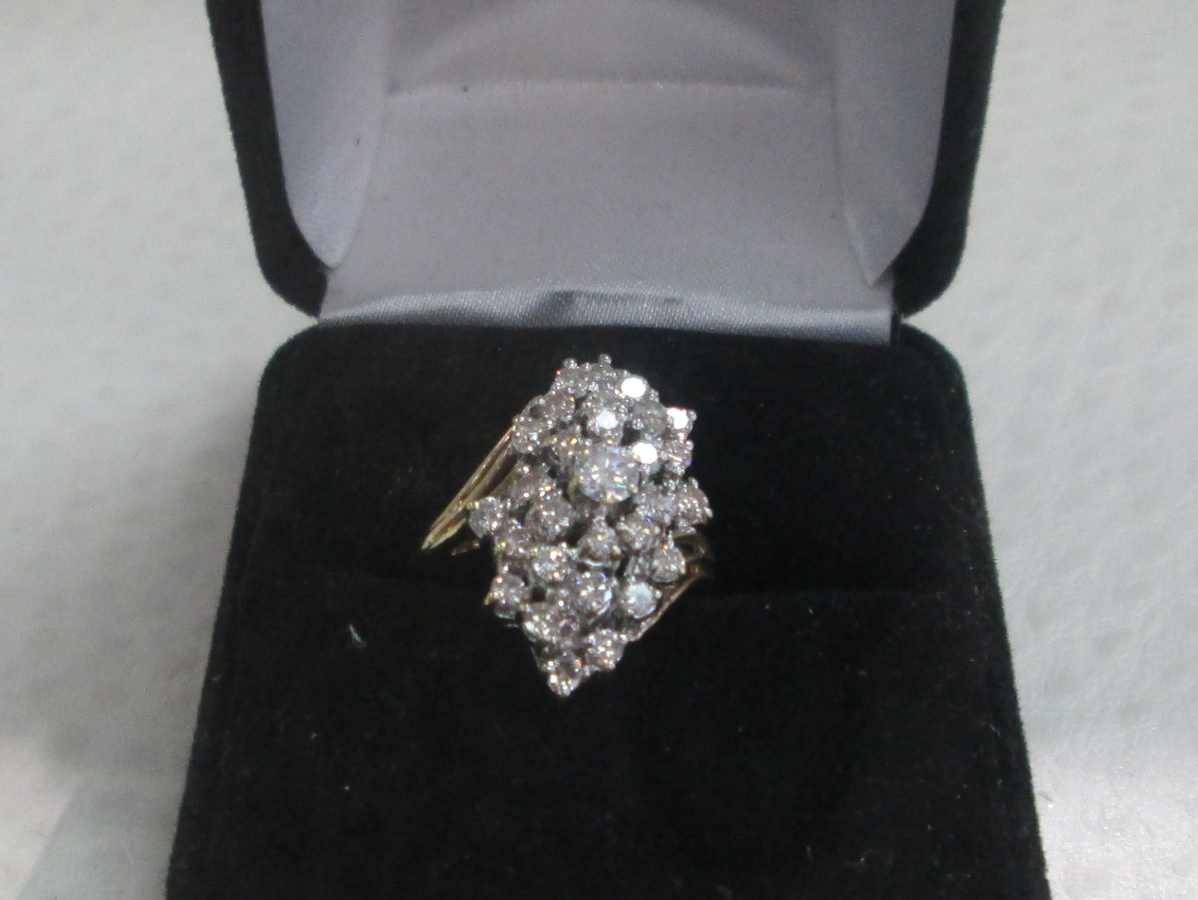 Diamond cluster ring in black ring box.