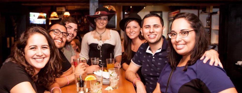 party of 6 with hostess at bar with drinks on table