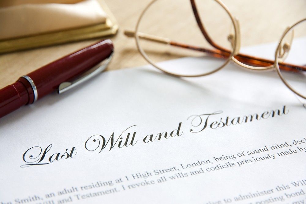 A Pen and Glasses Are on Top of a Law Will and Testament — Pollock Ingram Solicitors In Caloundra, QLD