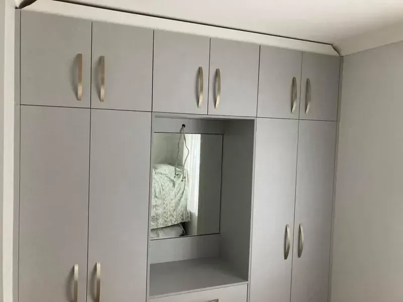 A Bedroom With a Lot of Cabinets and a Mirror — Moore Than Just Kitchens In Manilla, NSW