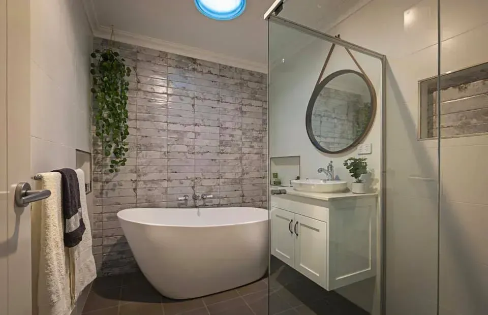 A Bathroom With a Bathtub, Sink, Mirror and Skylight — Moore Than Just Kitchens In Tamworth, NSW