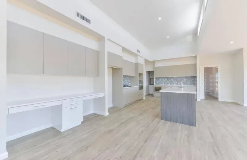 A large empty room with a kitchen and a desk. — Moore Than Just Kitchens In Manilla, NSW