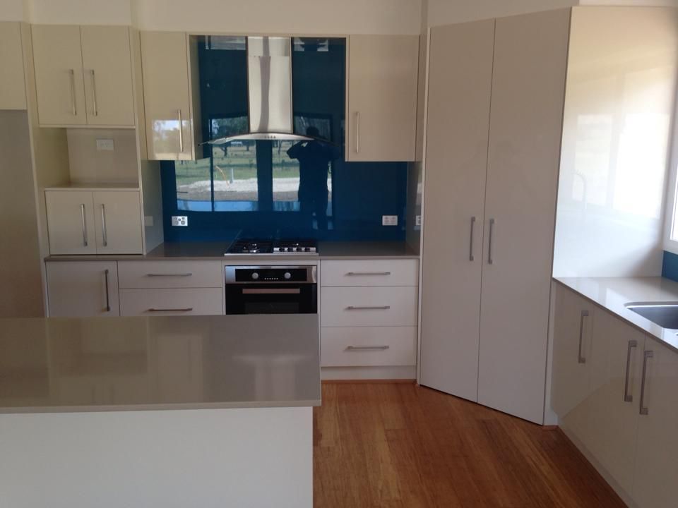 A Kitchen With White Cabinets and Stainless Steel Appliances — Moore Than Just Kitchens In Manilla, NSW