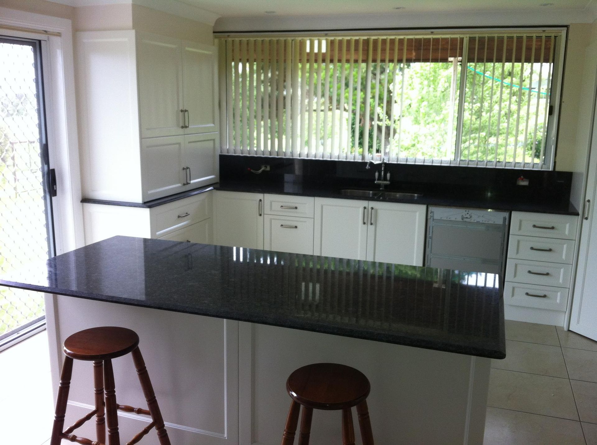 A Kitchen With Black Counter Tops and White Cabinets — Moore Than Just Kitchens In Narrabri, NSW