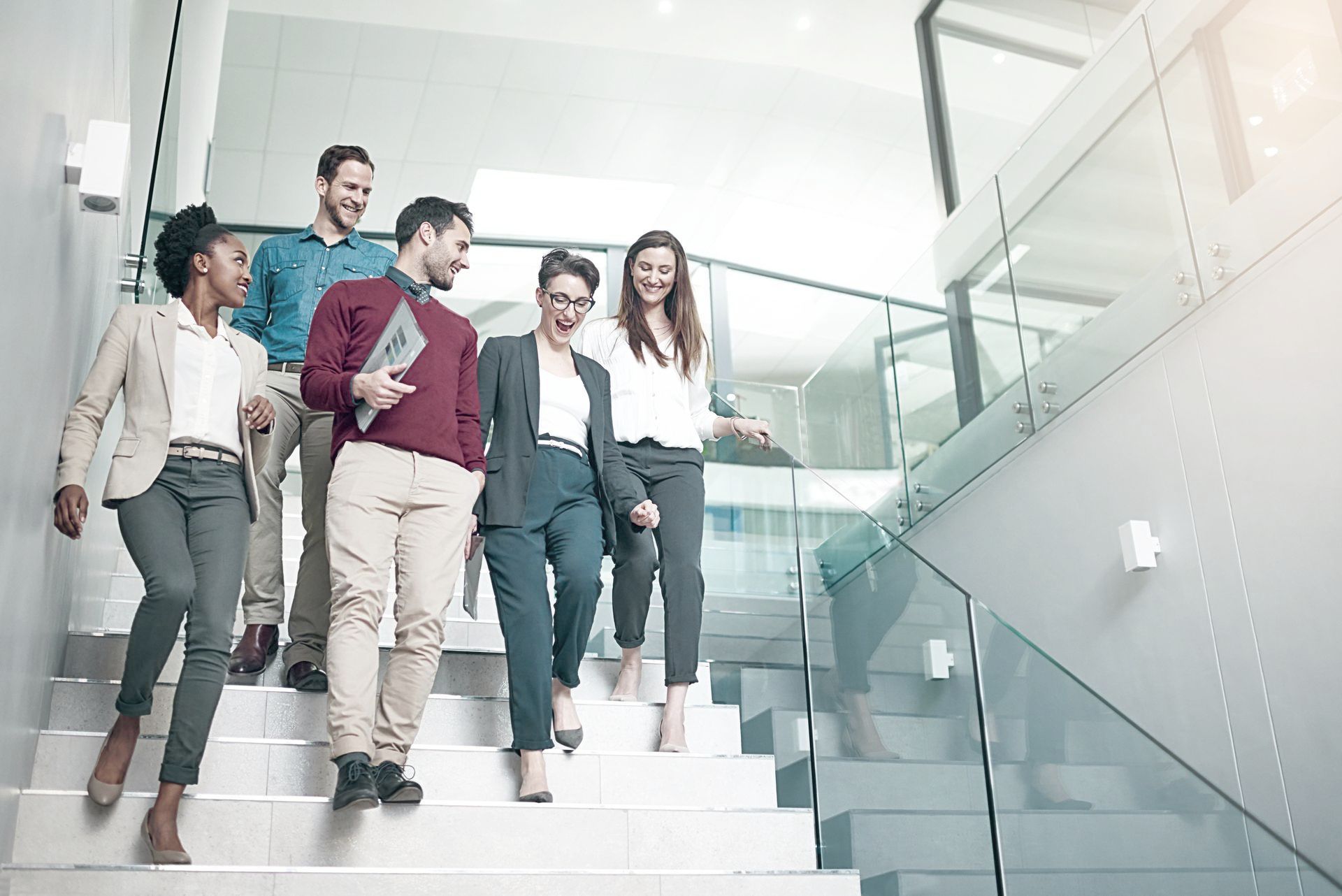 A group of people are walking down a set of stairs.