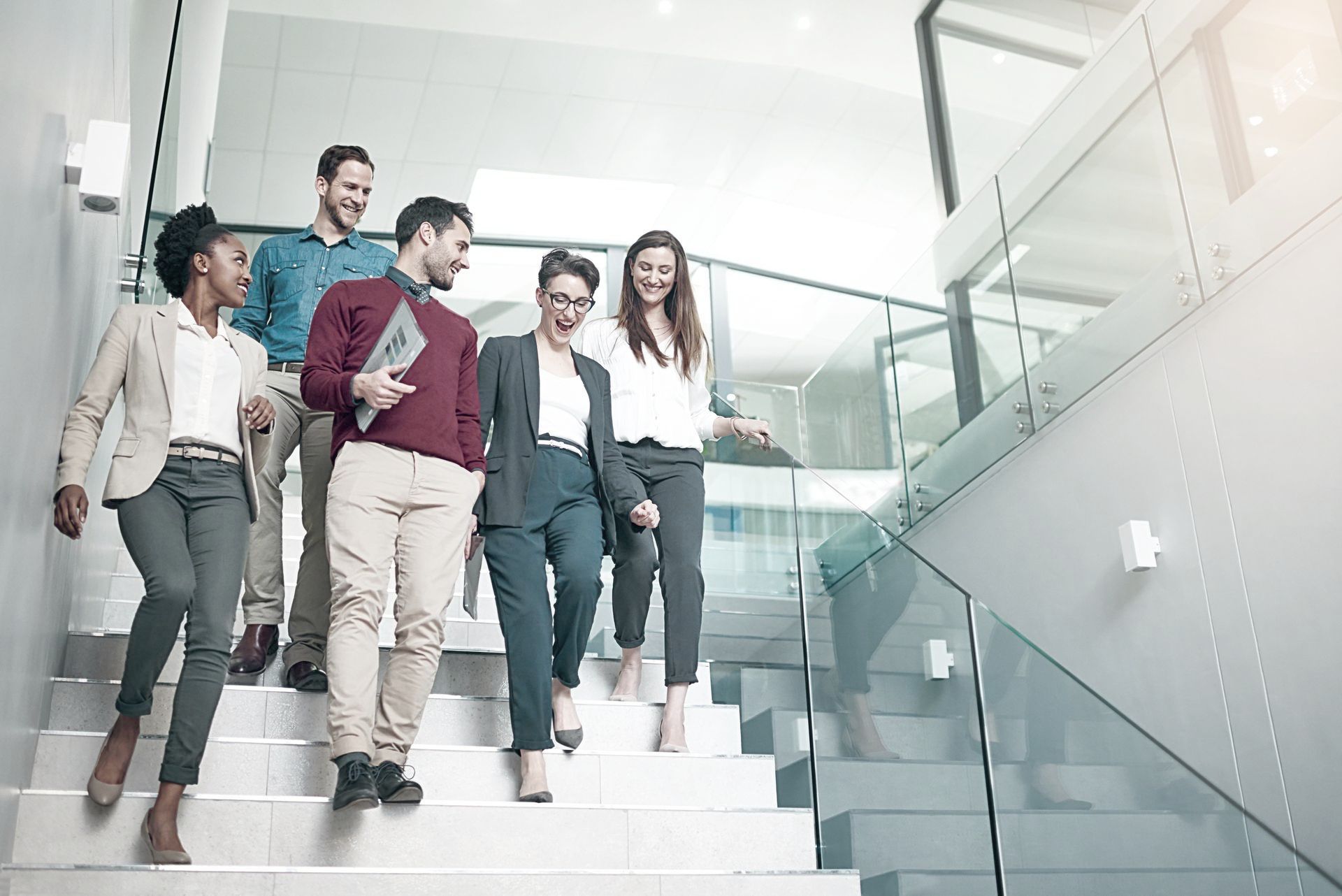 A group of employees are walking down a set of stairs.