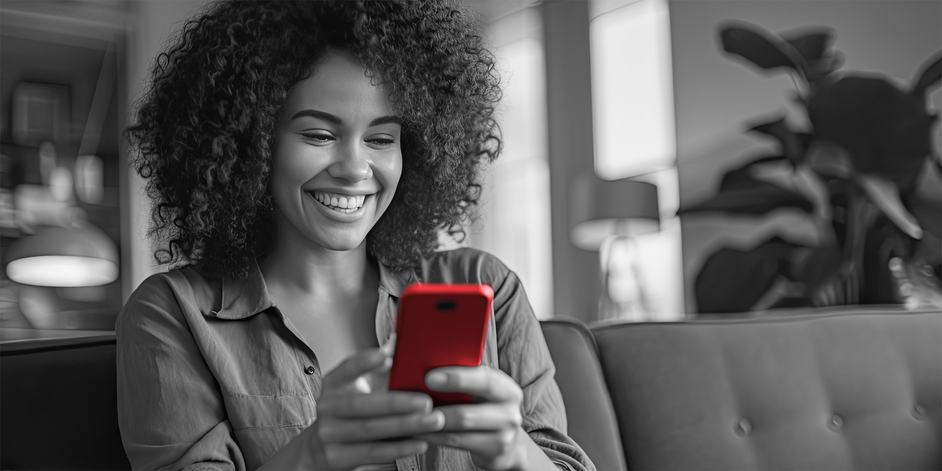 a woman is smiling while looking at her phone