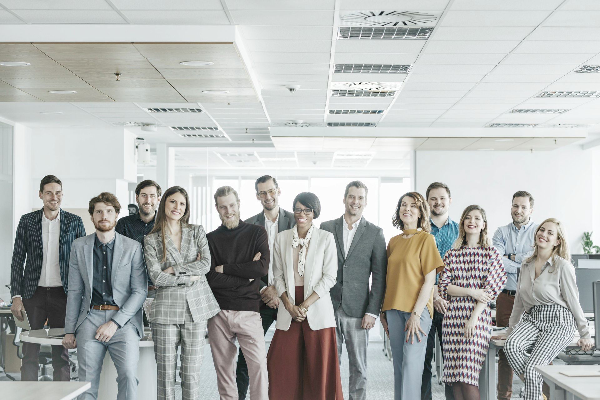 A group of people are posing for a picture in an office.