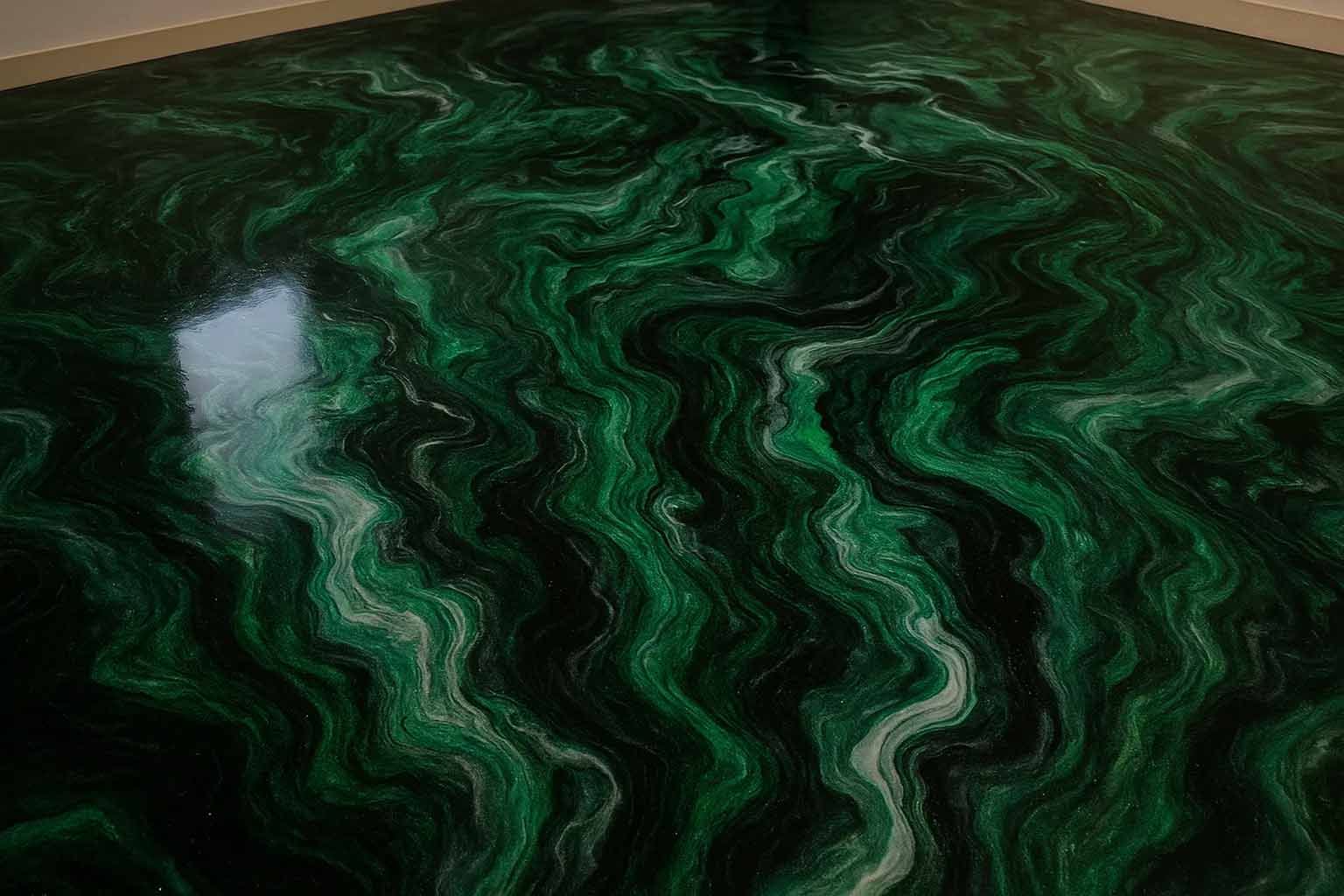Green and black epoxy floor with swirling patterns.