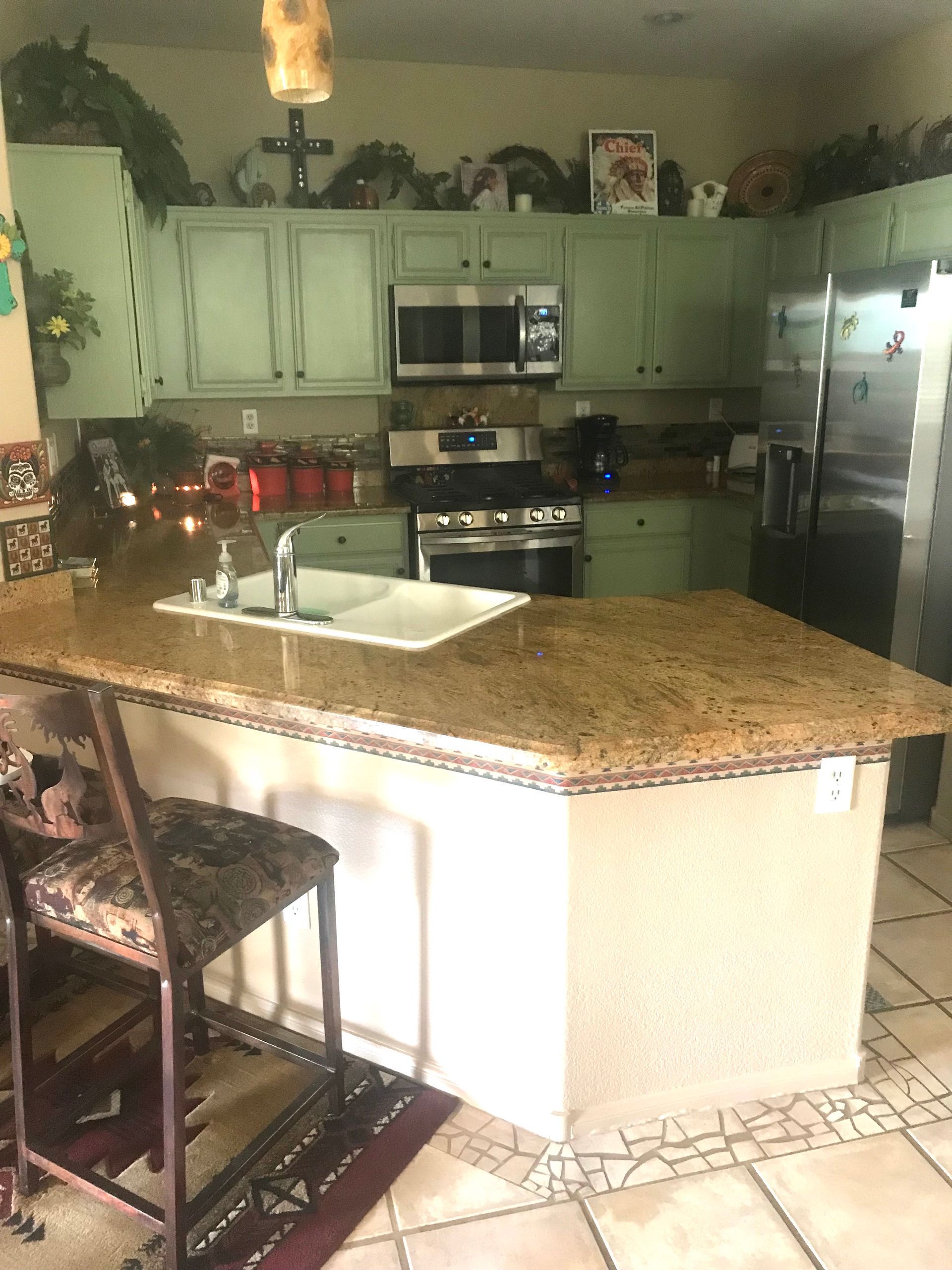 A kitchen with granite counter tops and stainless steel appliances