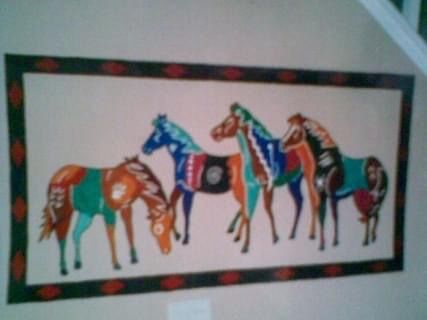 A colorful painting of horses on a wall