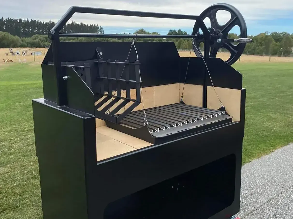 A black grill with a wheel on top of it