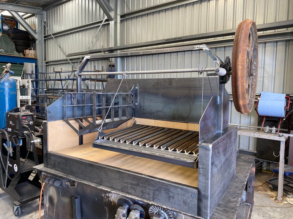 A large piece of metal is sitting on top of a table in a warehouse.