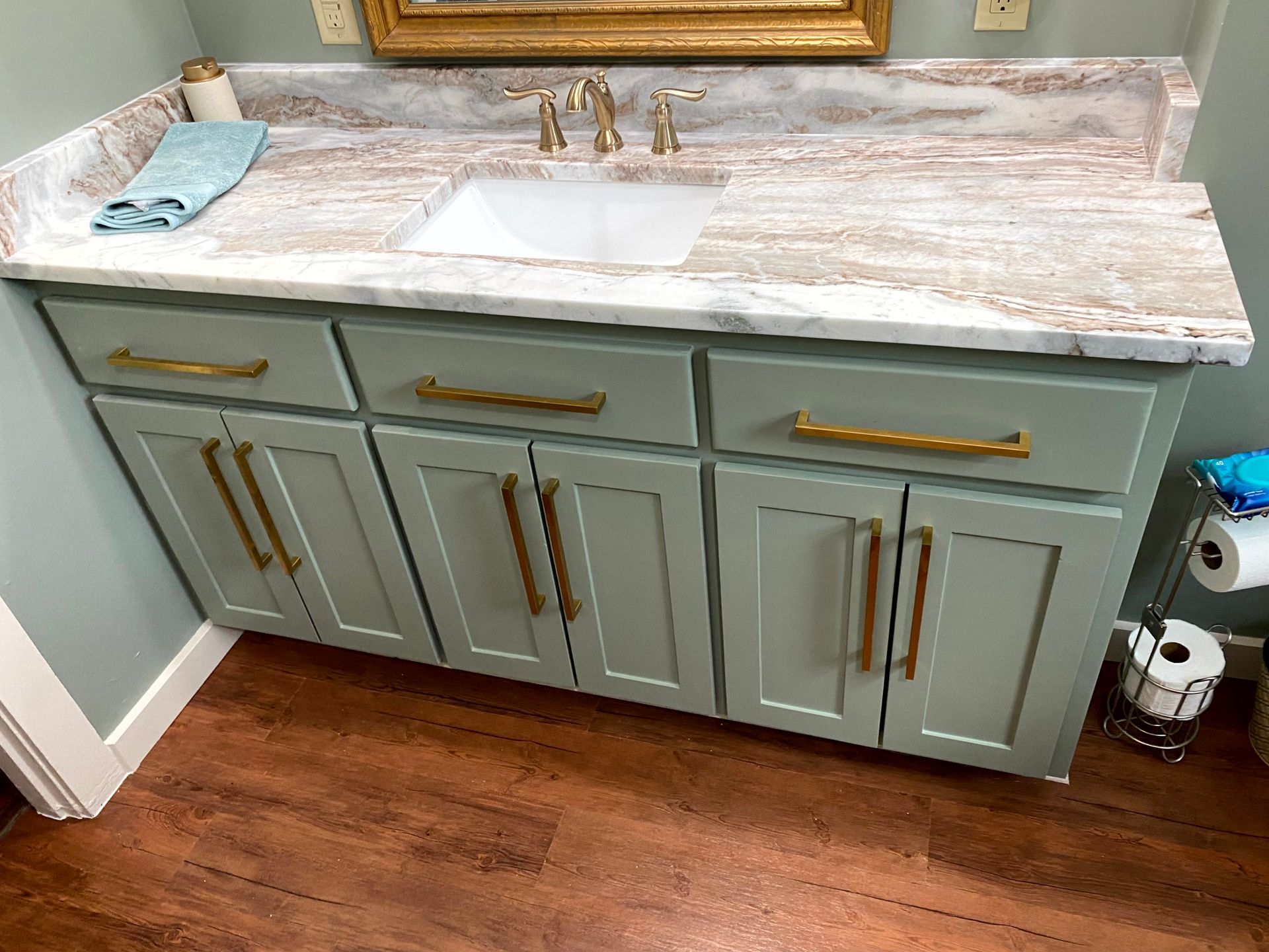 A bathroom vanity with a sink and a mirror built by remodeling contractors.
