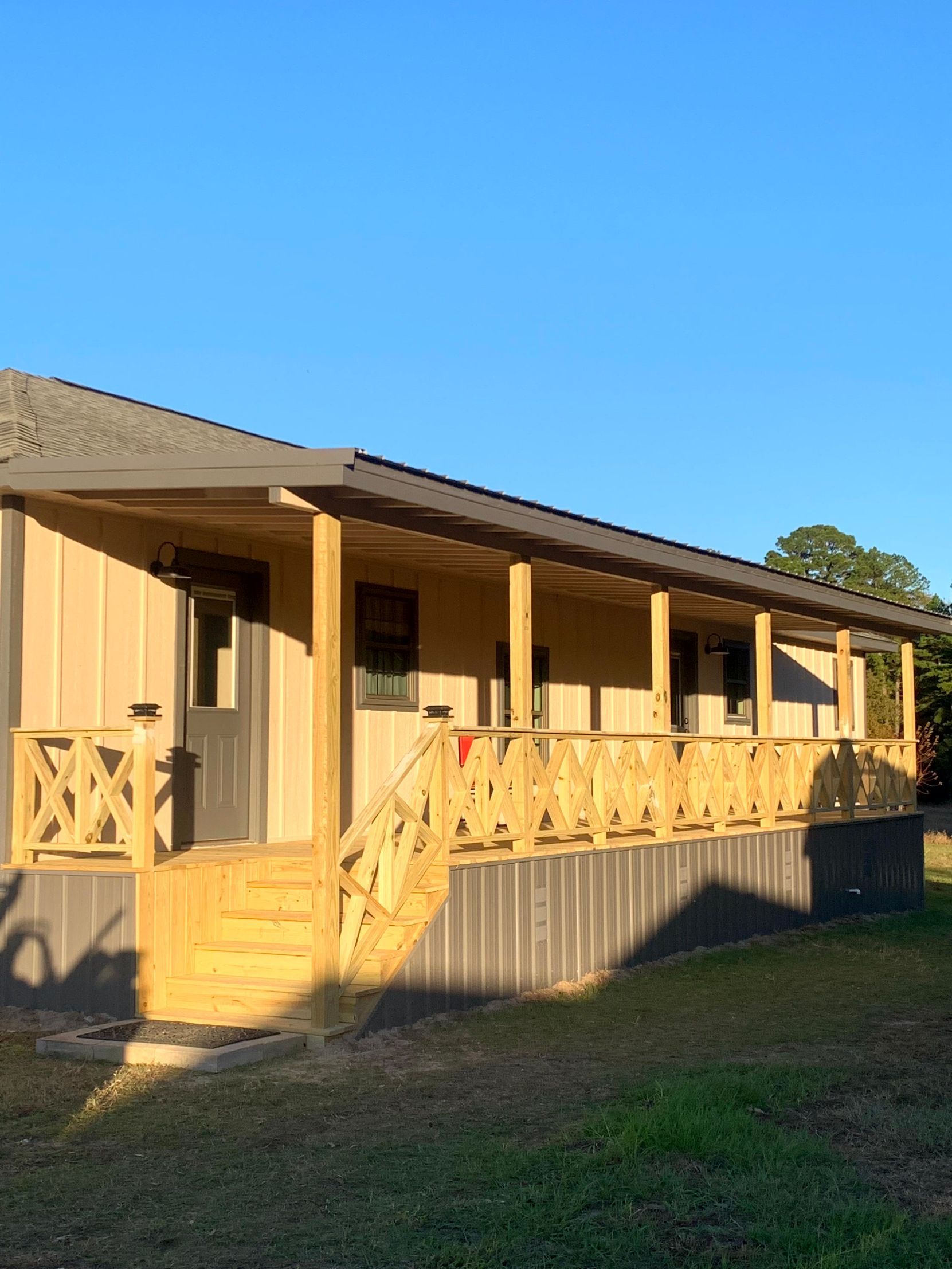 A house with a large porch and stairs by remodeling contractors.