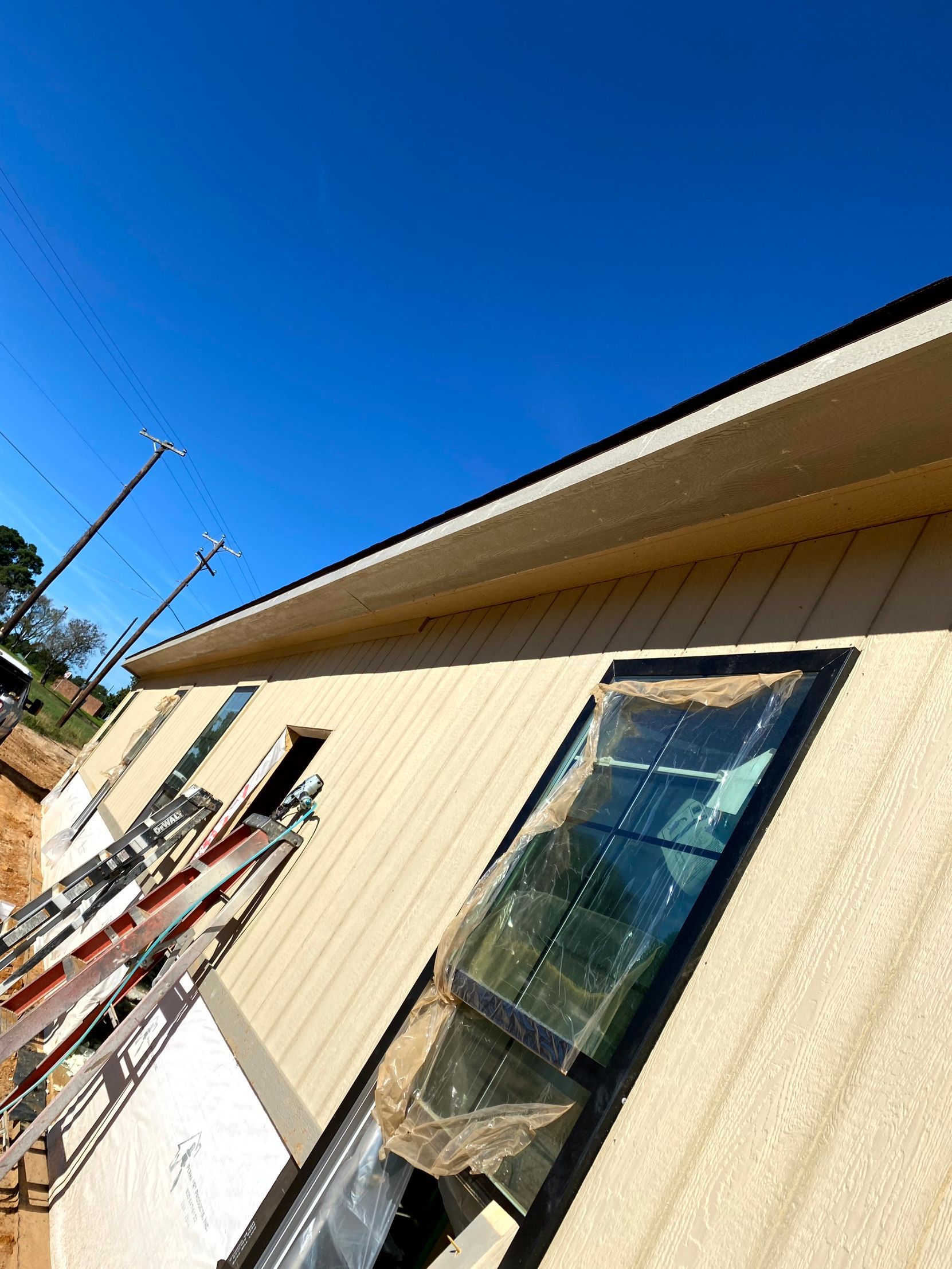A building under construction with a window by remodeling contractors.