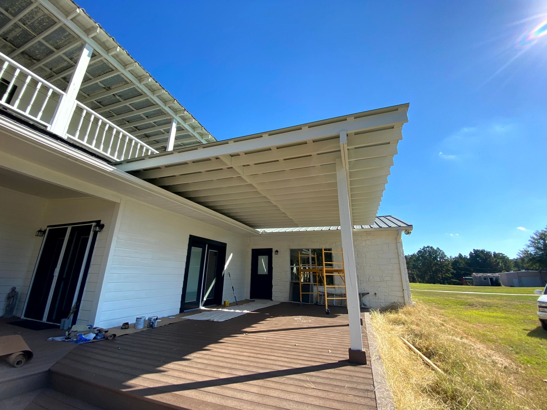 A white house with a covered porch made by home renovating contractors.