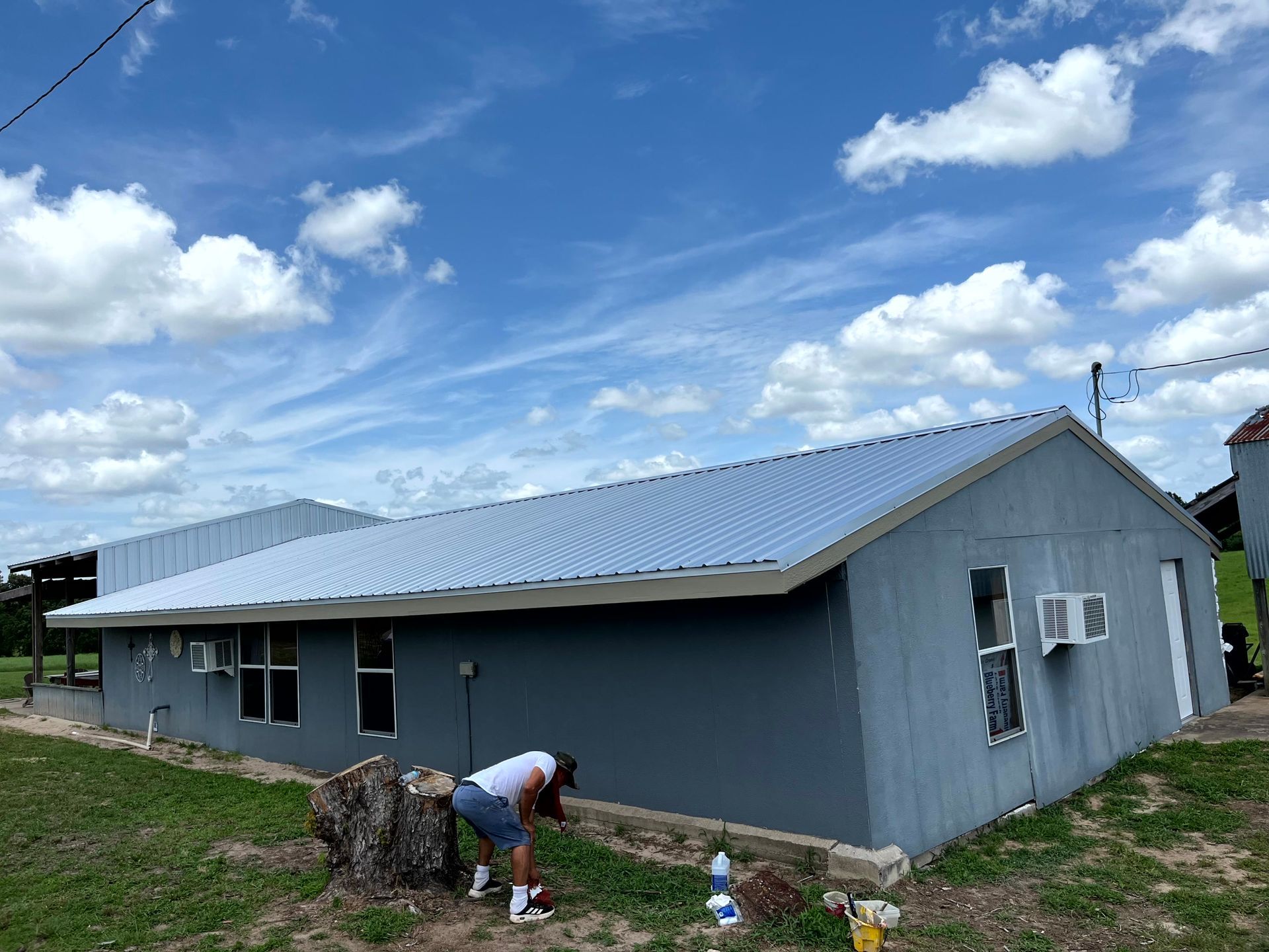 A man is installing a metal roof.