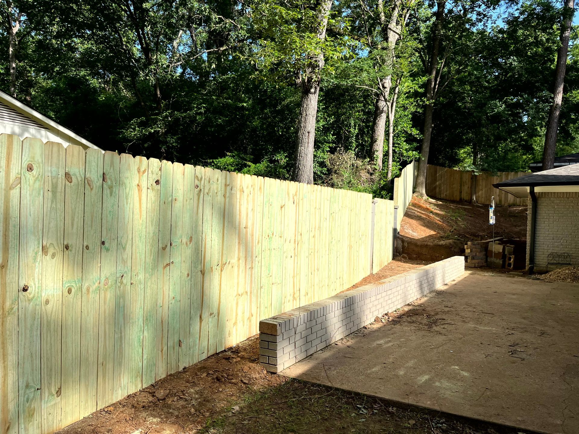 A wooden fence in a backyard by remodeling contractors.