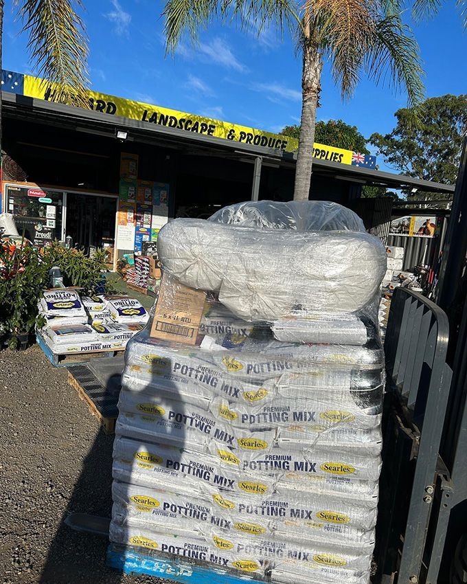 A Stack of Bags of Potting Mix on Top of a Forklift — Howard Landscape and Produce Supplies in Hervey Bay, QLD