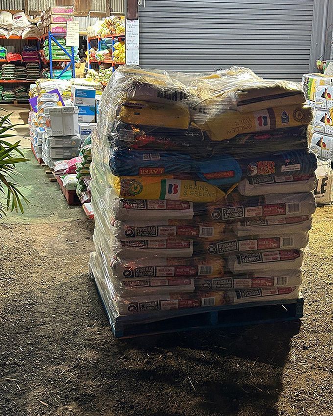 A Pallet Filled With Bags of Dog Food in a Warehouse — Howard Landscape and Produce Supplies in Bundaberg, QLD