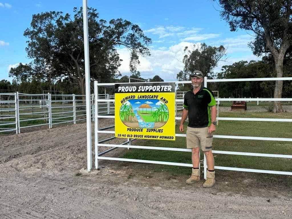 A Man is Standing in Front of a Fence — Howard Landscape and Produce Supplies in Howard, QLD
