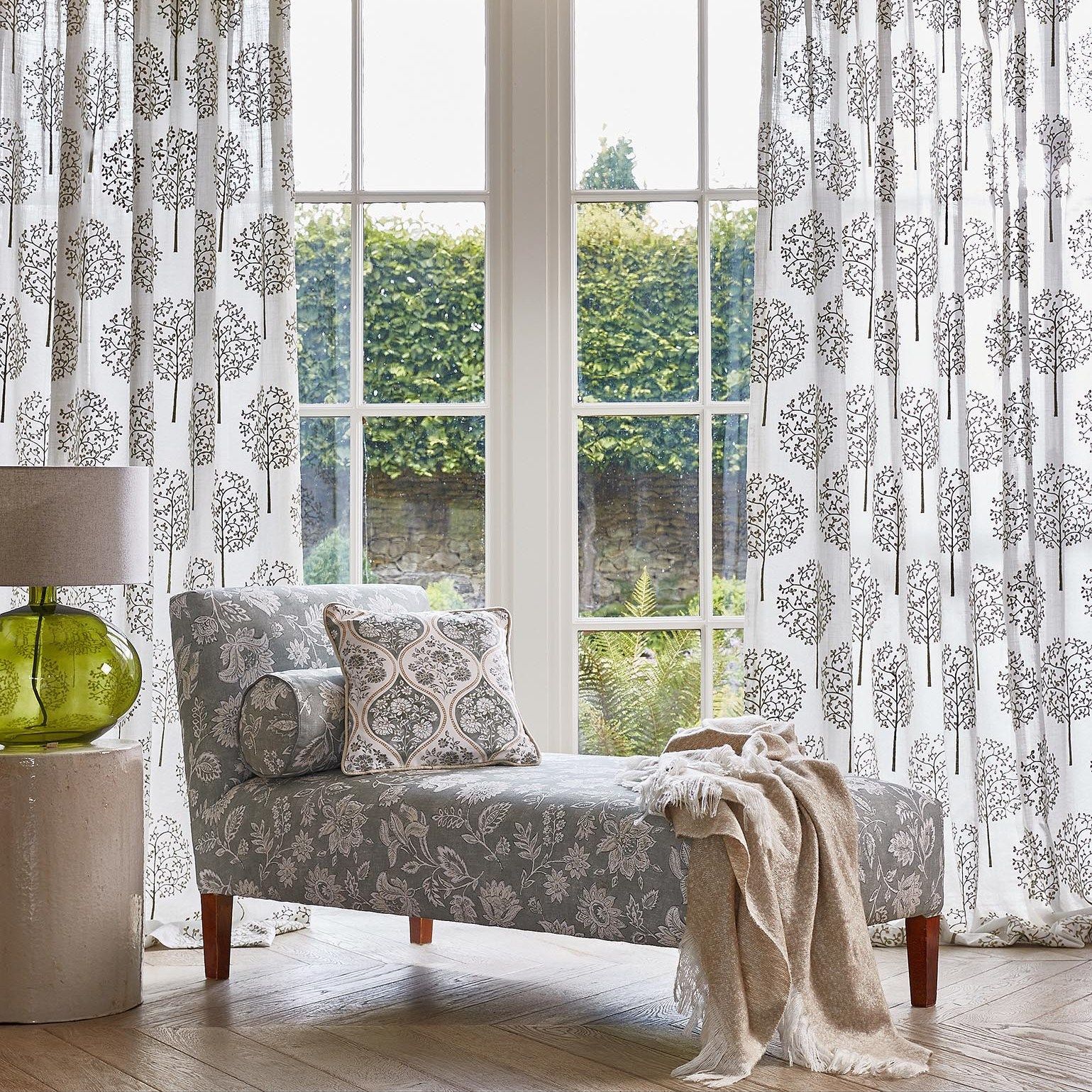 Un soggiorno con una chaise longue e una lampada