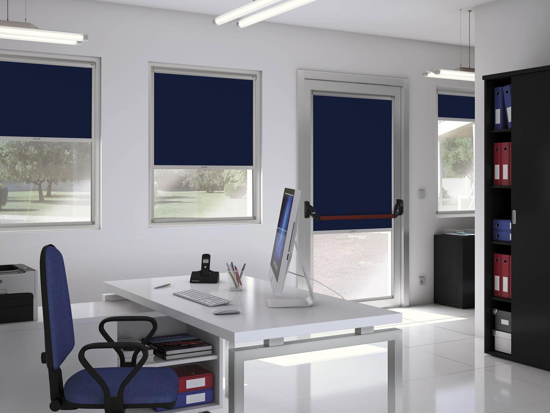 Un ufficio con le tende blu e una scrivania con un computer sopra