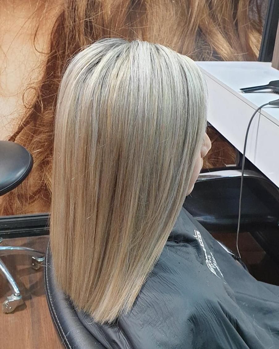 Woman With Crimped, Blonde Hair Sitting in a Salon Chair — Studio 23 In Biggera Waters, QLD