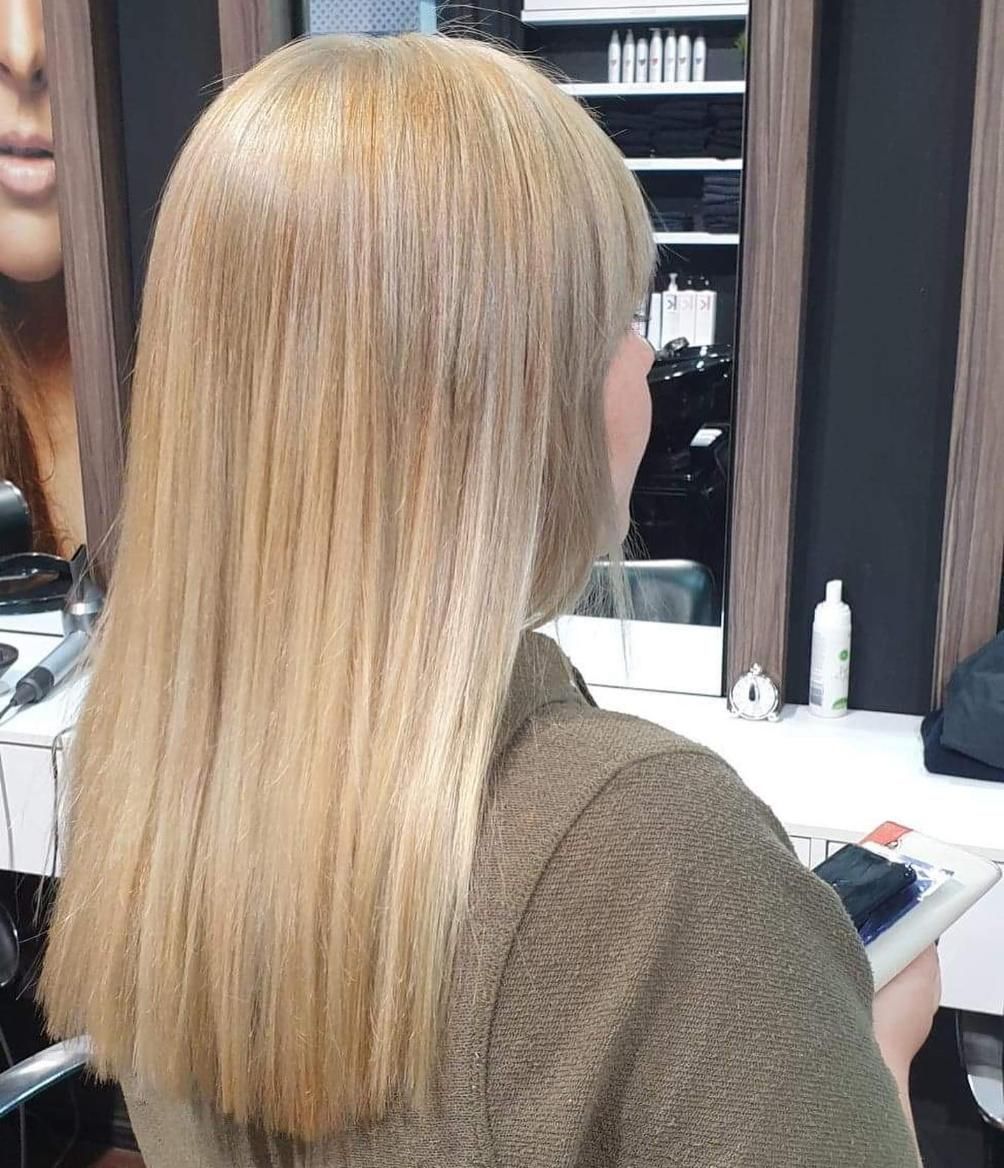 Woman With Straight, Light Blonde Hair in a Salon Setting — Studio 23 In Biggera Waters, QLD