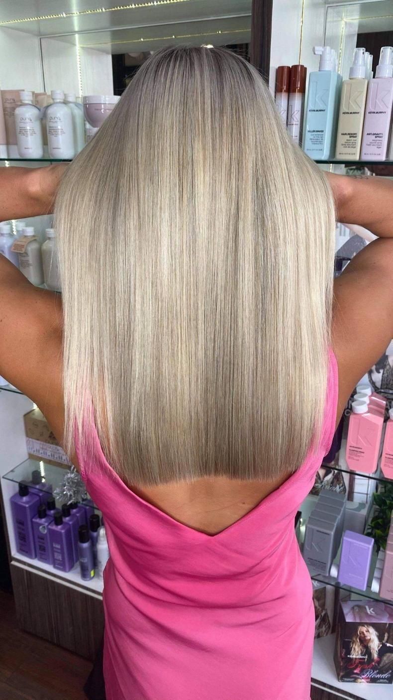 Woman With Long Blonde Hair Holding Arms Up, Standing in a Hair Salon — Studio 23 In Biggera Waters, QLD