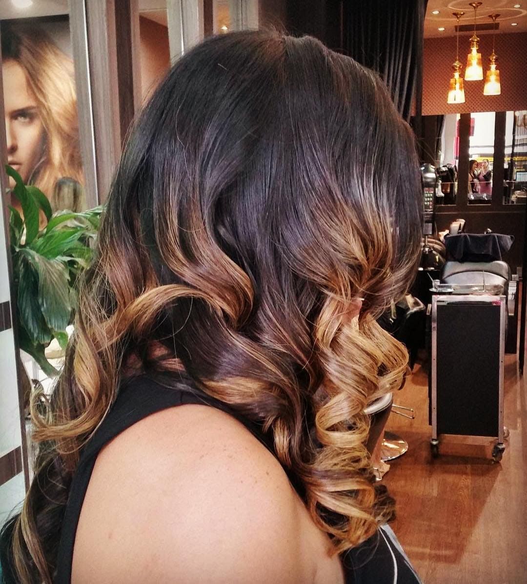 Woman With Dark Brown to Blonde Ombre Hair Styled in Loose Curls at a Salon — Studio 23 In Biggera Waters, QLD
