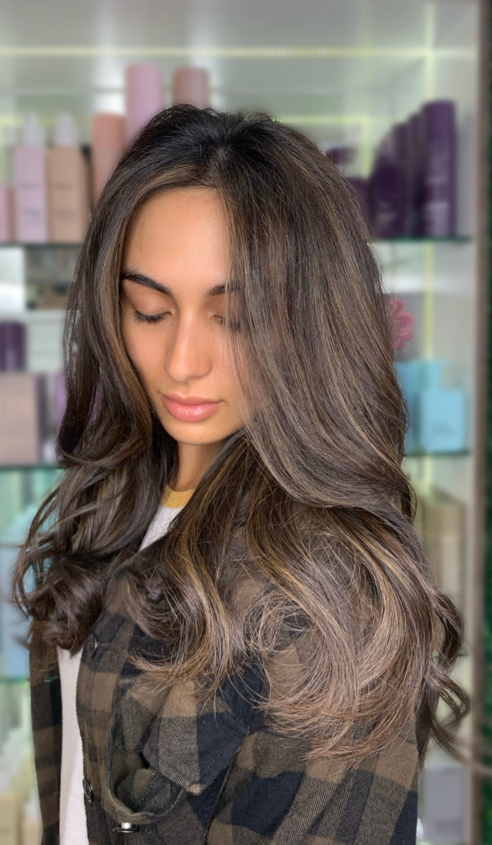 Woman With Long Dark Hair, Smiling, in a Salon — Studio 23 In Biggera Waters, QLD