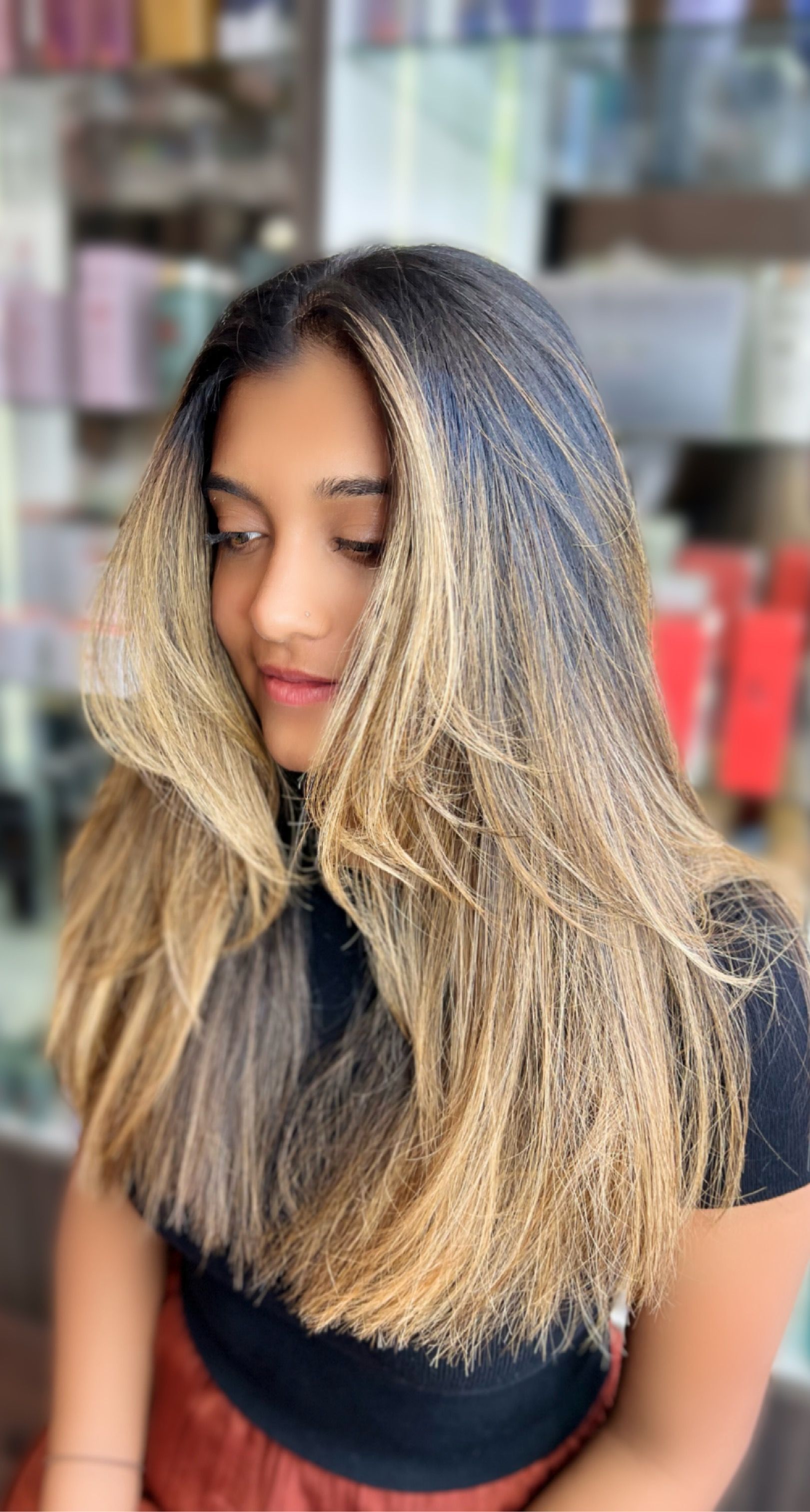 Woman With Wavy, Ombre Blonde Hair, Wearing a White Sweater, Standing Near a Brick Wall — Studio 23 In Biggera Waters, QLD
