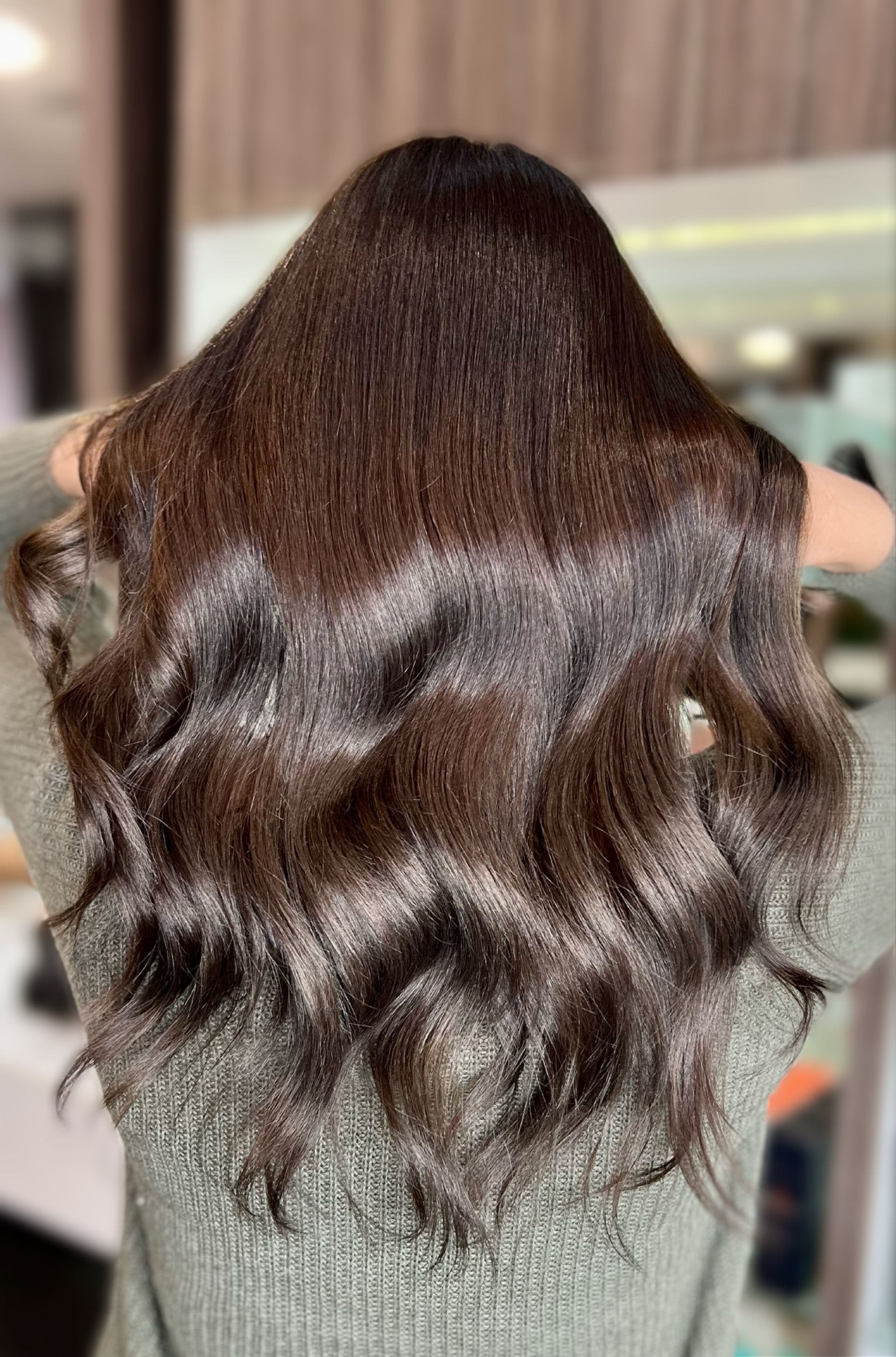 Shiny, dark brown wavy hair, held up, reflecting light — Studio 23 In Biggera Waters, QLD